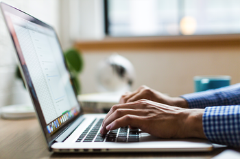 Person typing on laptop